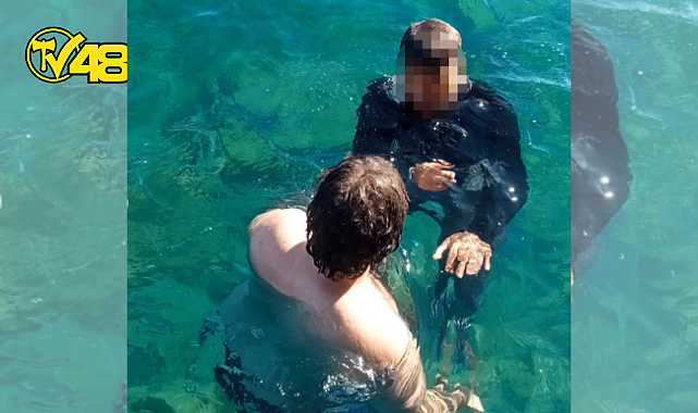 AYAĞINA KUM TORBASI BAĞLAYARAK İSKELEDEN ATLAYAN ŞAHIS BASIN MENSUPLARI TARAFINDAN KURTARILDI